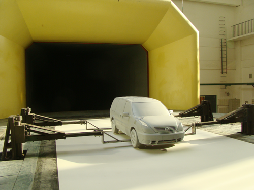 Automotive wind tunnel with simulating effect of moving ground